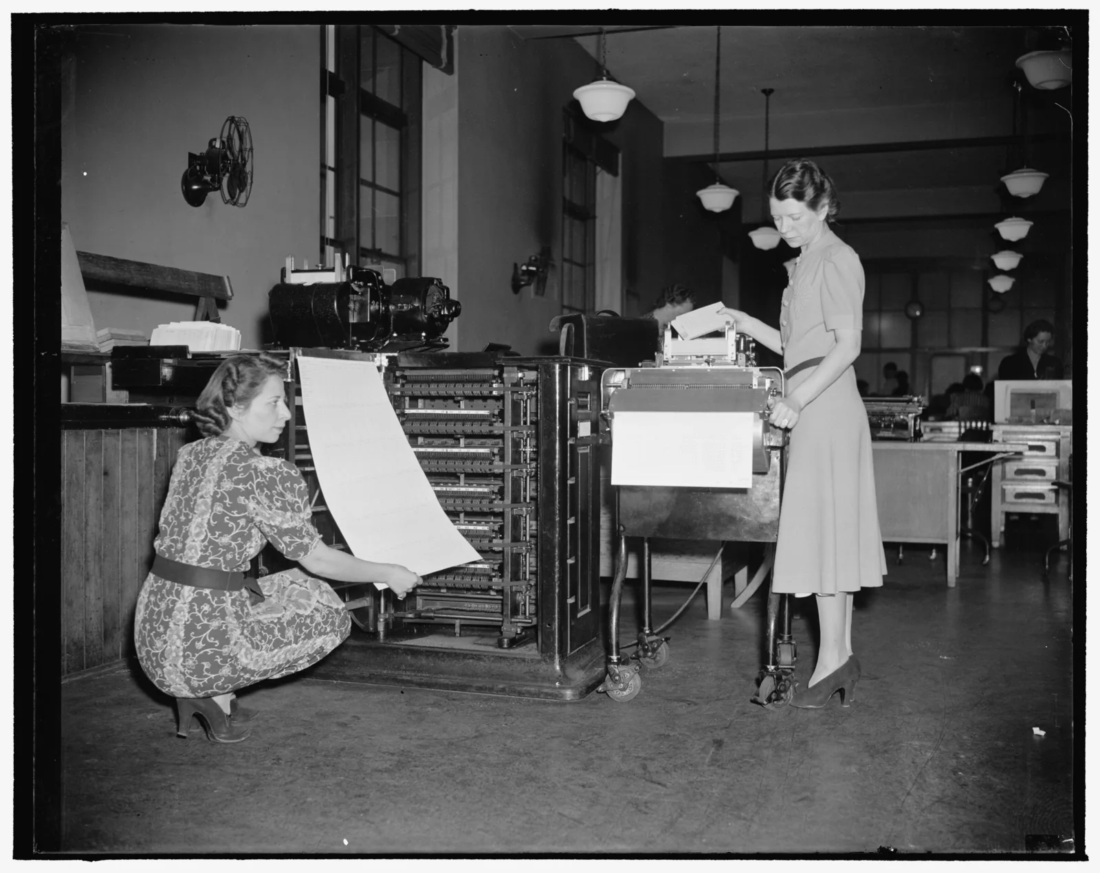 Census Bureau statisticians operating tabulating machines to process 1940 census data in Washington, D.C.
