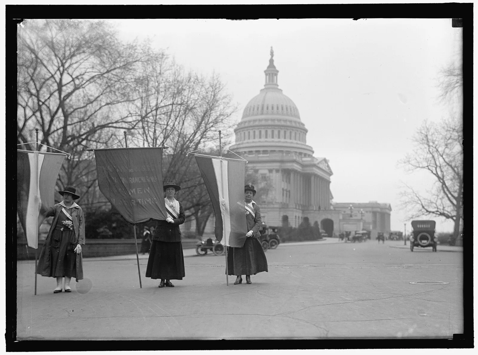 Suffragists picket at the U.S. Capitol with banners demanding the vote for women, around 1917
