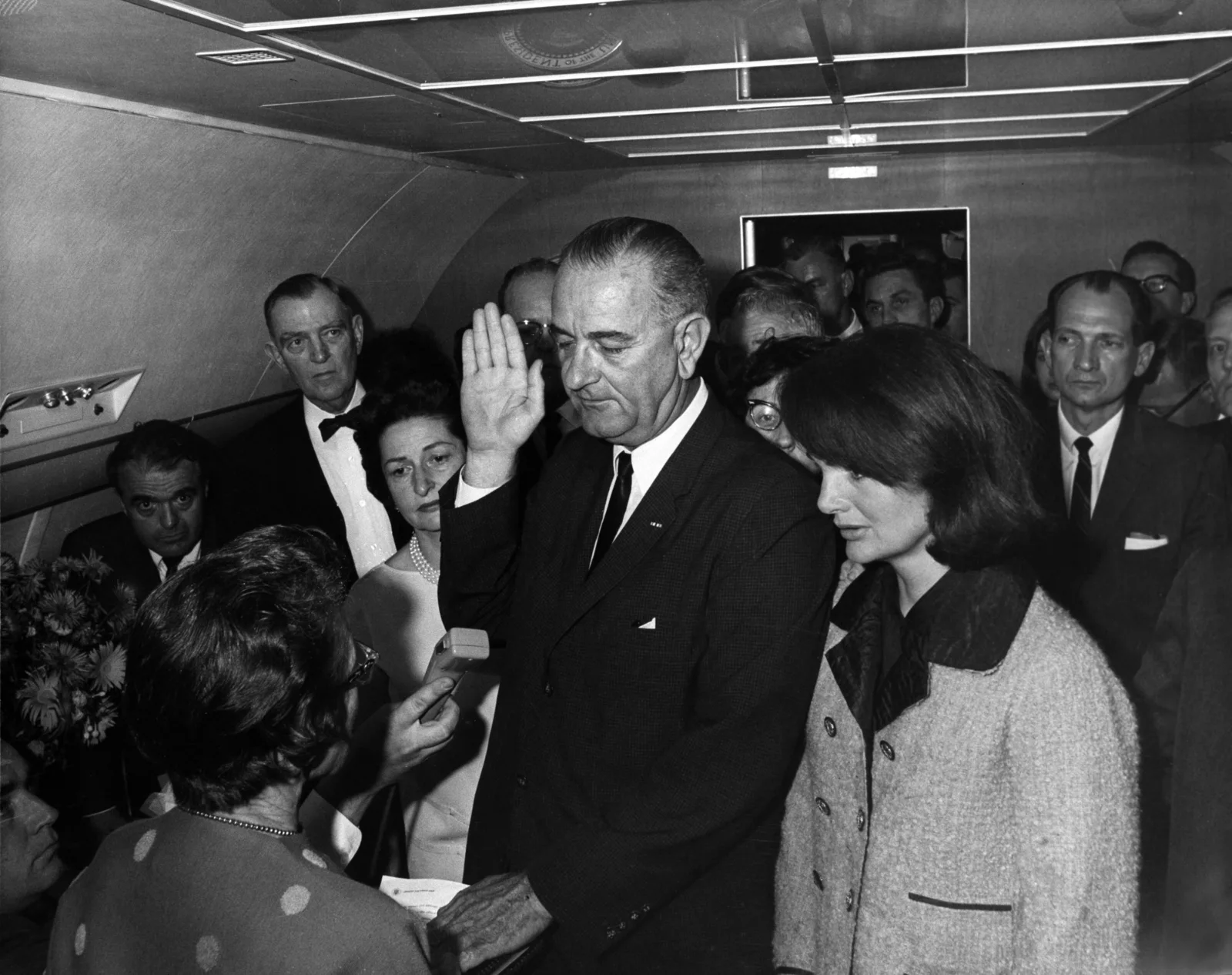 Lyndon B. Johnson takes the presidential oath of office from Judge Sarah T. Hughes aboard Air Force One at Dallas Love Field on November 22, 1963, hours after President Kennedy's assassination.