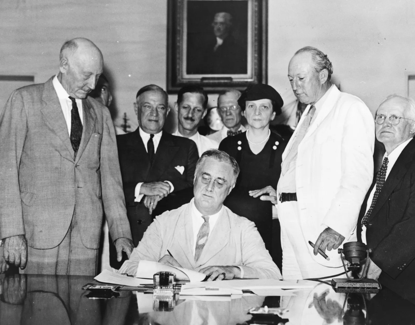 President Franklin D. Roosevelt signing the Social Security Act in the White House Cabinet Room, August 14, 1935