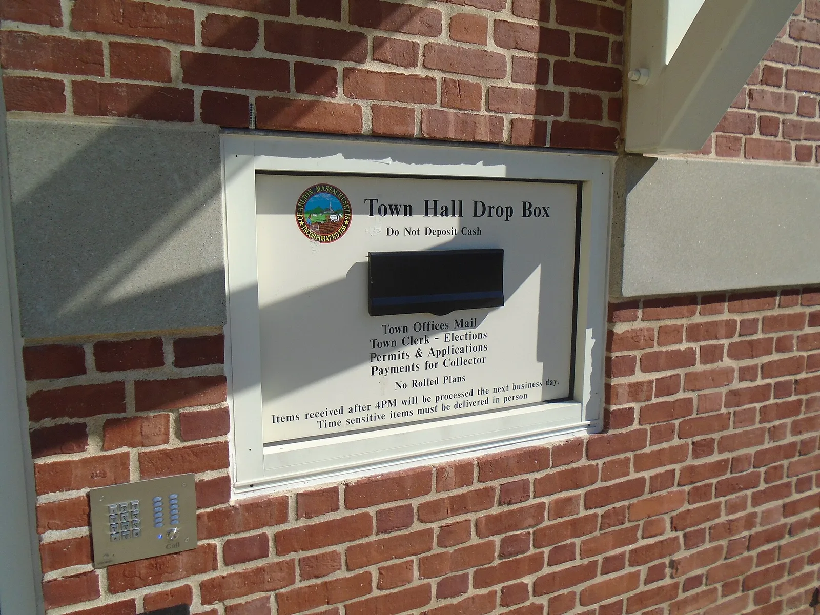 A secure ballot drop box built into the brick wall of a Massachusetts town hall