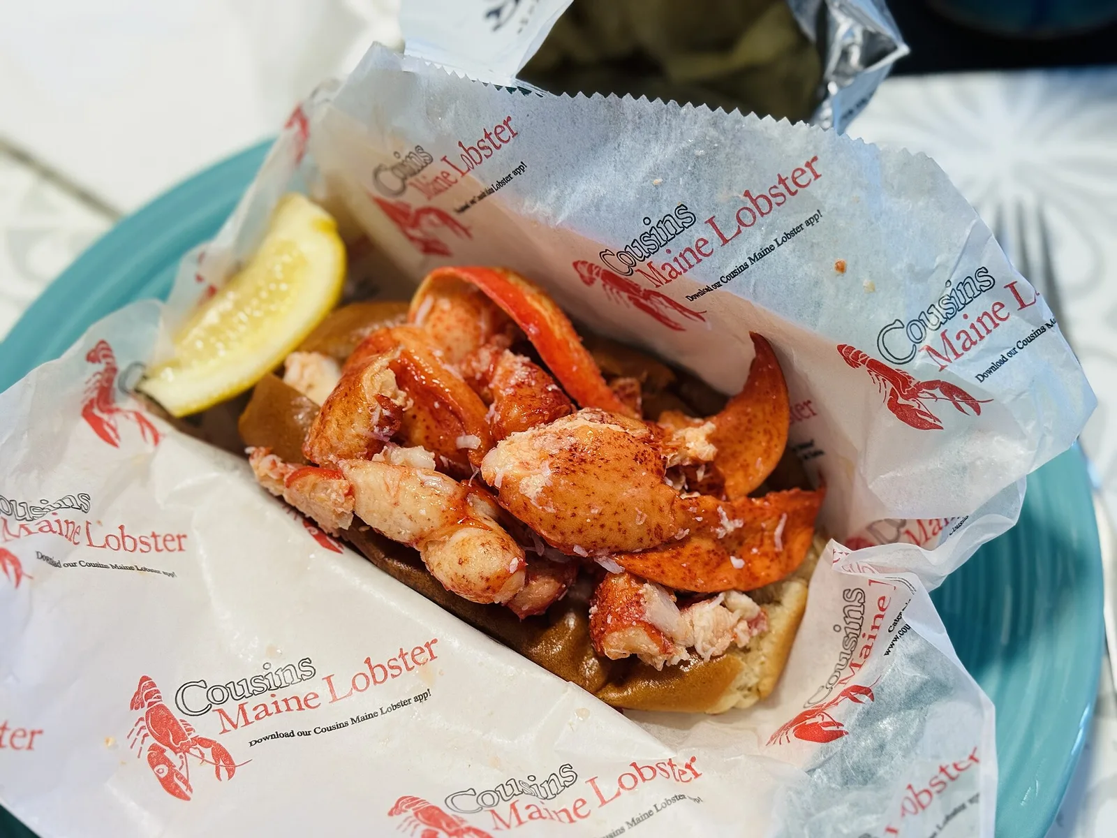 Fresh Maine lobsters in a wooden crate on a working wharf