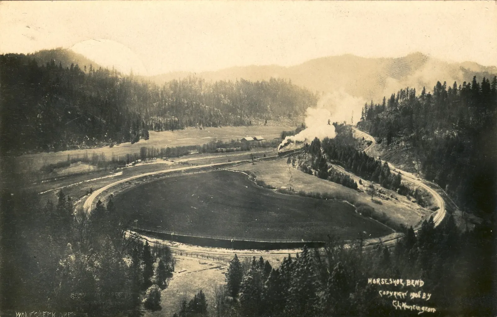 The Pacific Railway & Navigation Company's newly built line curving around Horseshoe Bend west of Timber, Oregon, in 1908, the single track cut into a steep forested hillside