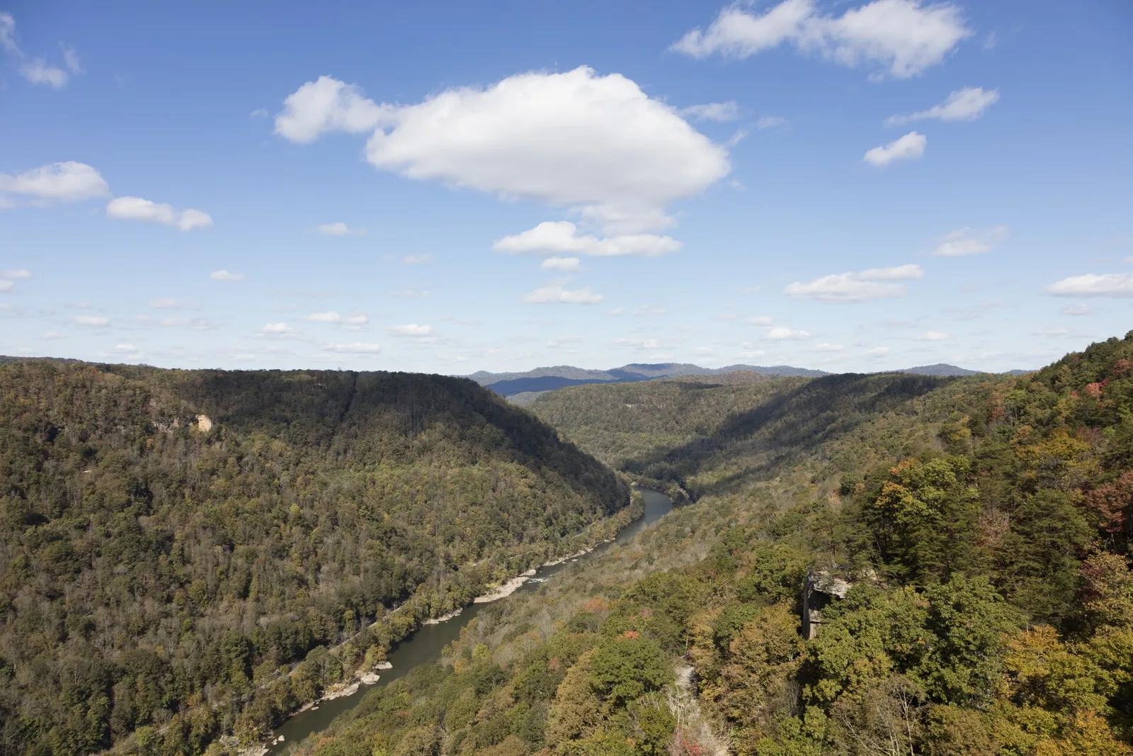 The New River Gorge Bridge spanning a thousand-foot-deep canyon in New River Gorge National Park, West Virginia, with forested mountain ridges rising on either side of the steel arch