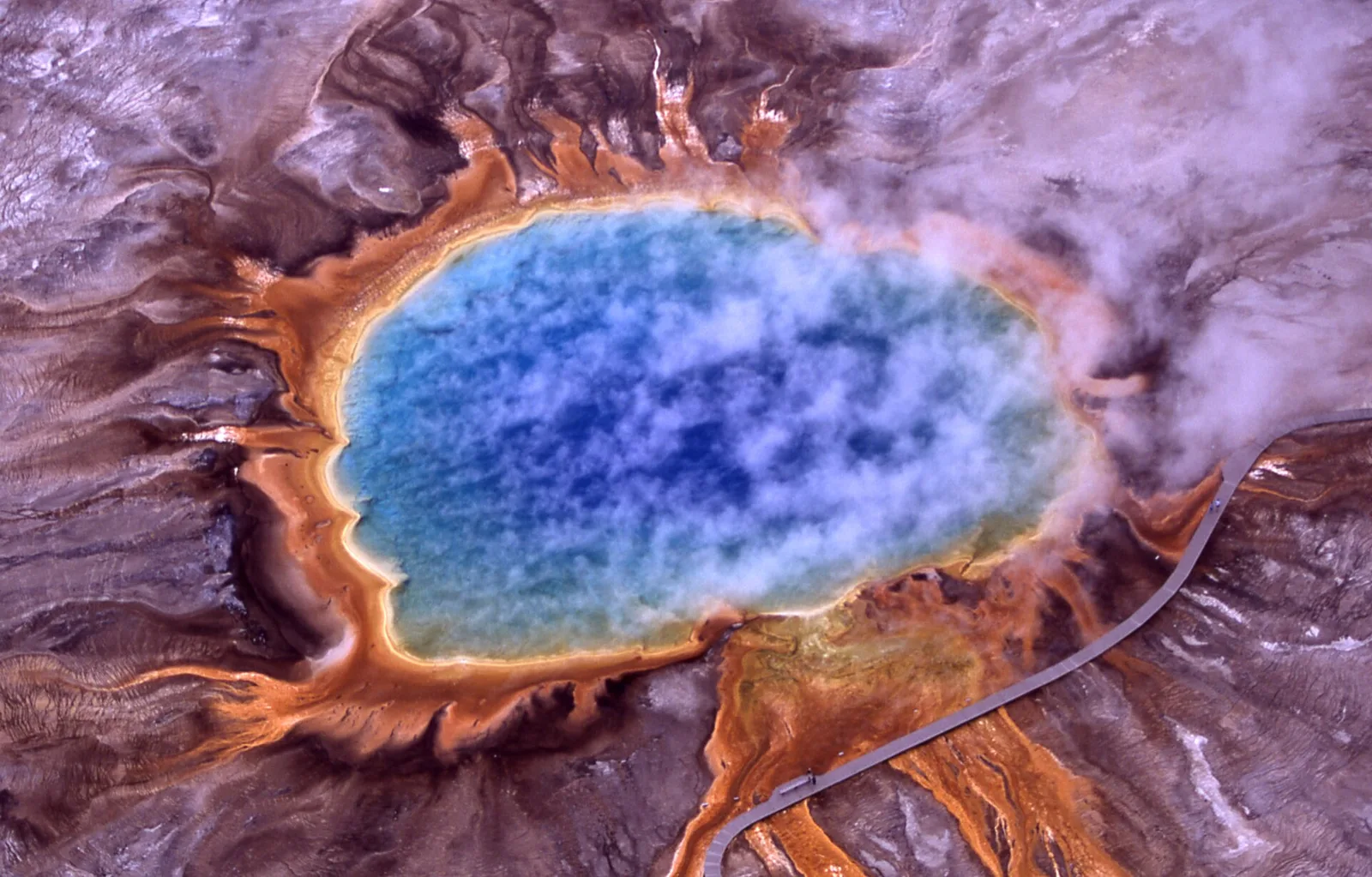 The vivid concentric bands of blue, green, yellow, and orange in Grand Prismatic Spring, the third-largest hot spring on Earth, at Yellowstone National Park, Wyoming